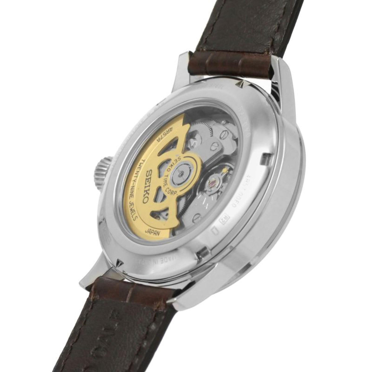 Seiko watch caseback with visible gears and brown leather strap, silver steel case