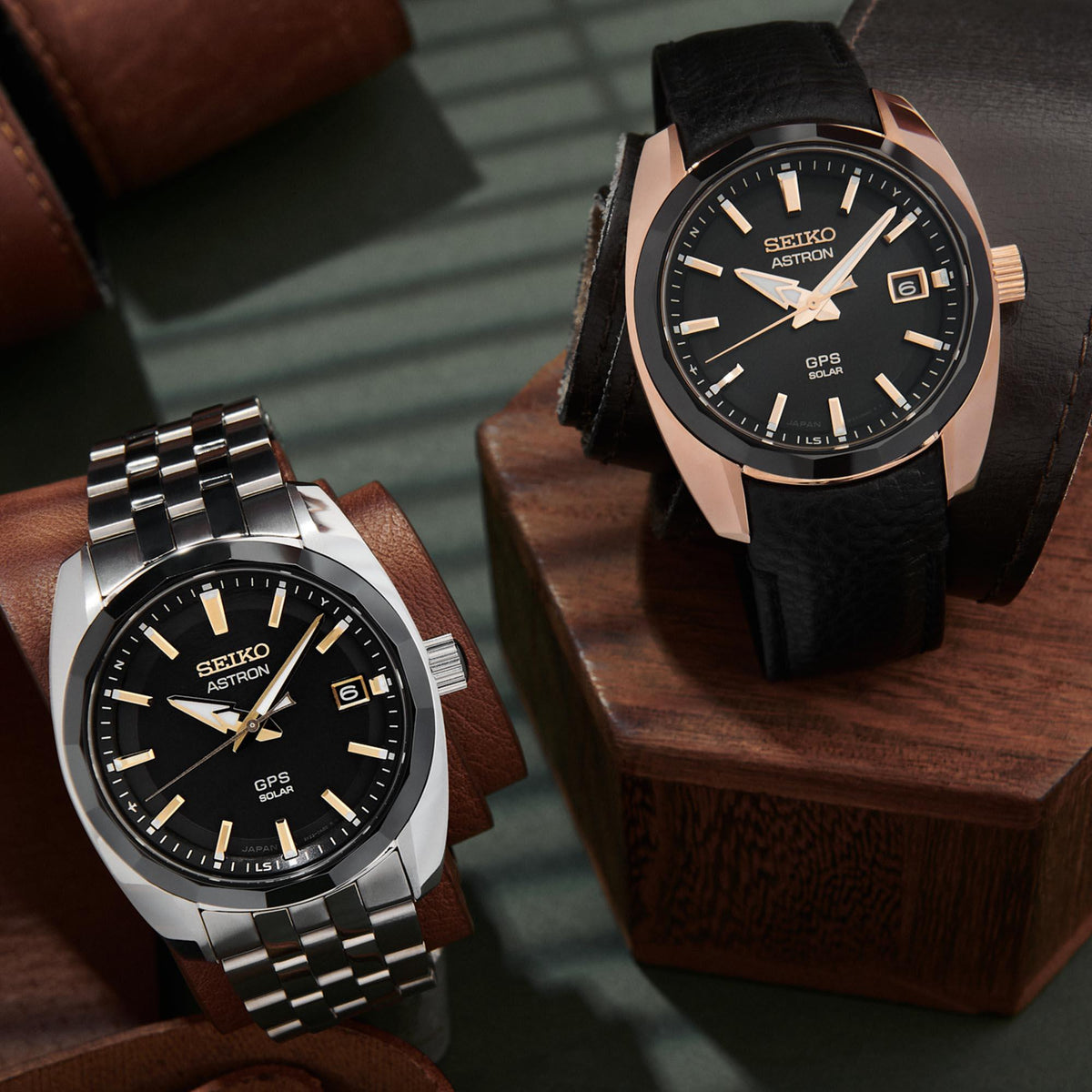 Two men's GPS solar watches with black dials: black leather strap and metal bracelet.