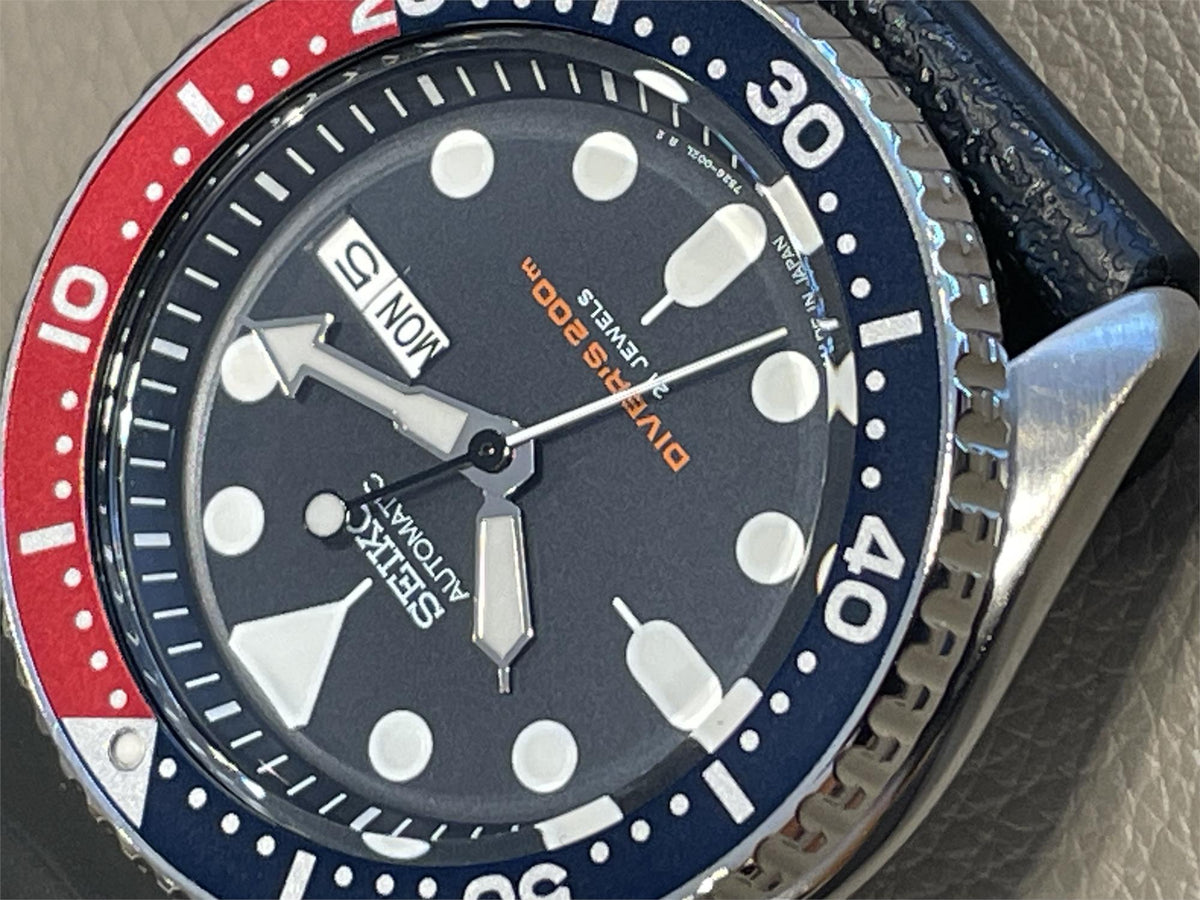 Close-up of the lower half of the dial, highlighting the orange "DIVER'S 200m" text and "MADE IN JAPAN" marking at the bottom edge.
