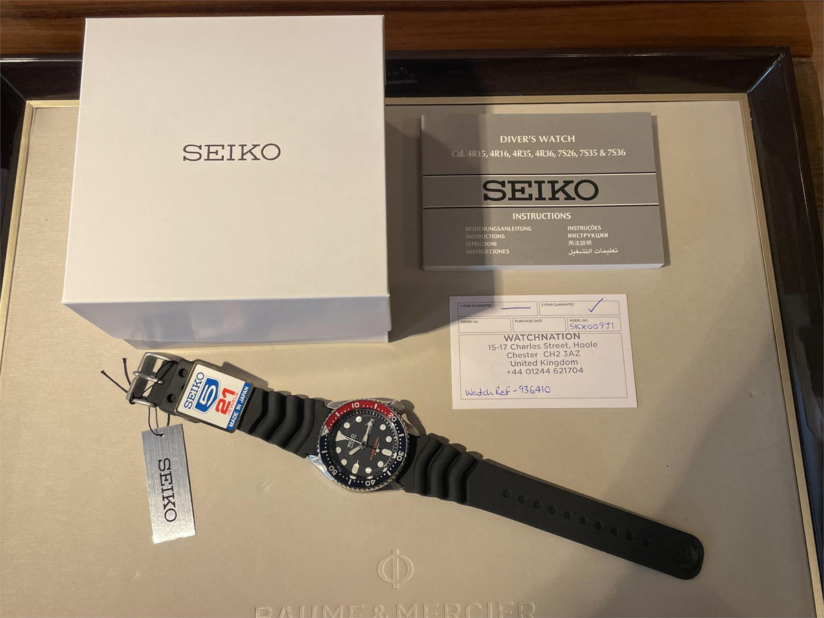 Seiko SKX009J1 watch with packaging box and accessories