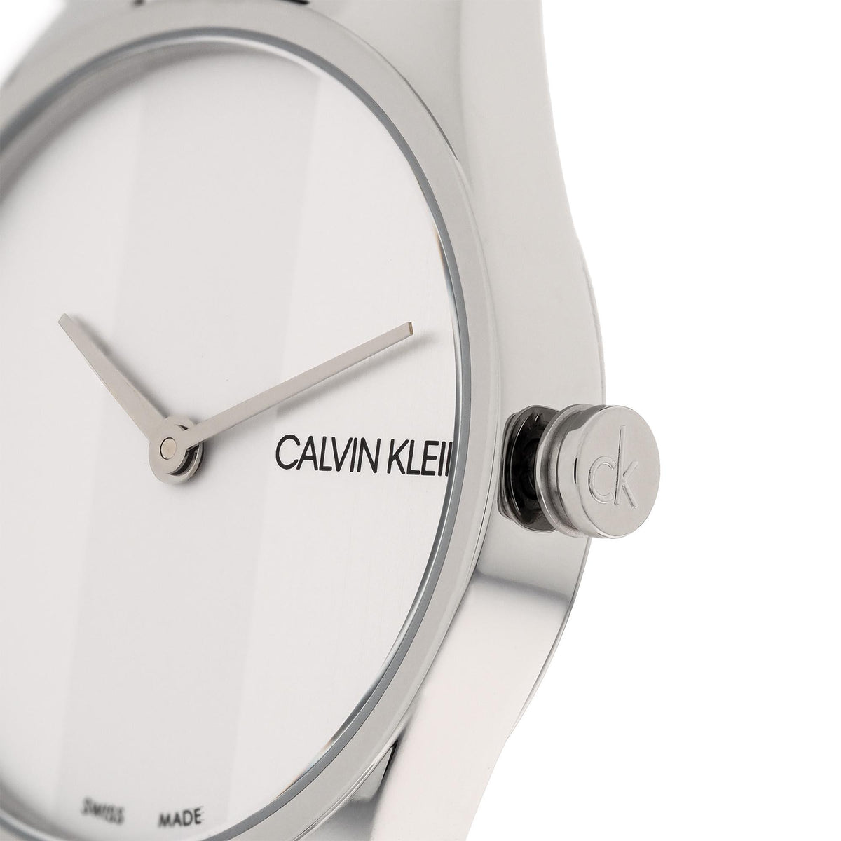 Calvin Klein quartz watch close-up showing CK crown on silver case and white dial hands