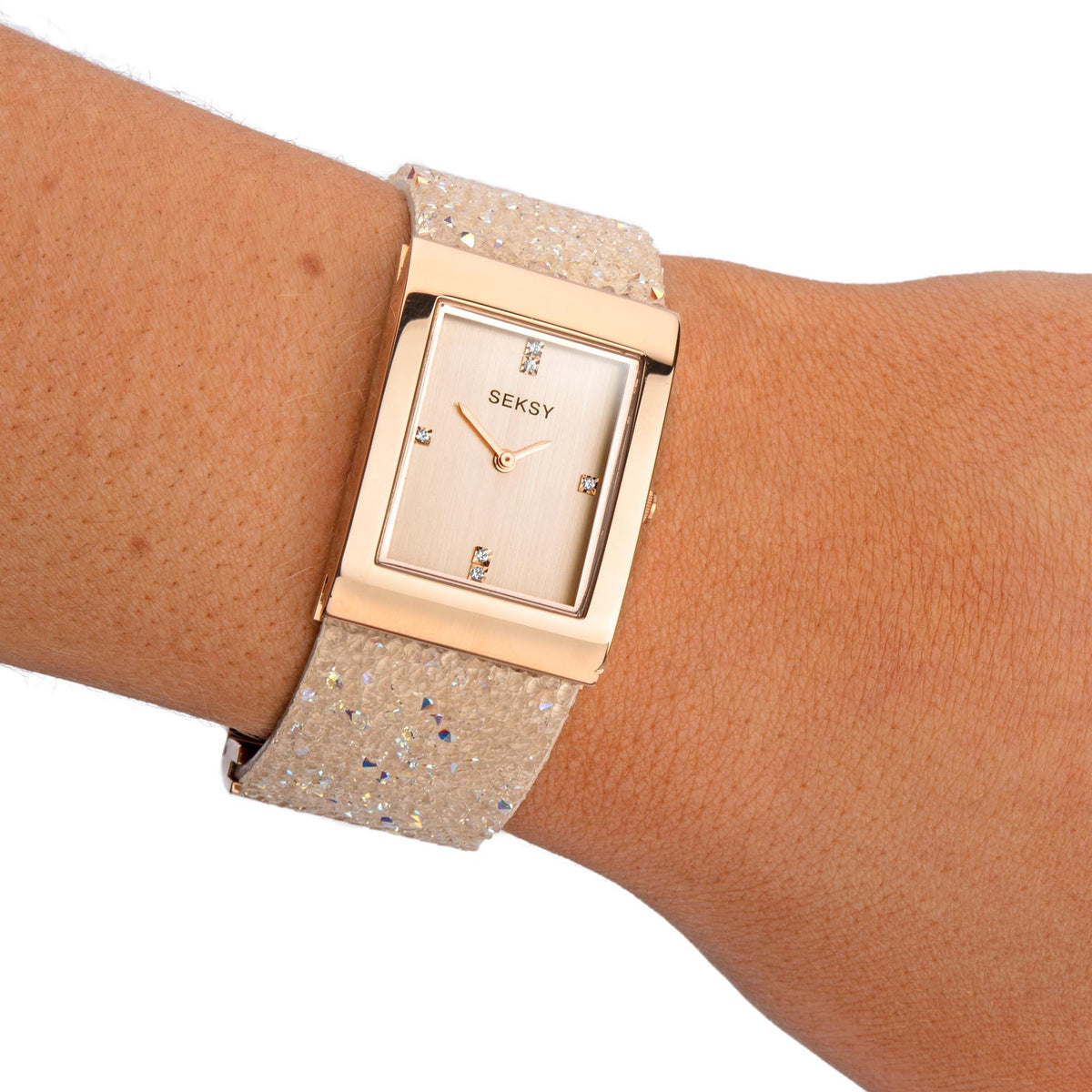Quartz watch on wrist with rose gold square dial and sparkling glitter bracelet strap