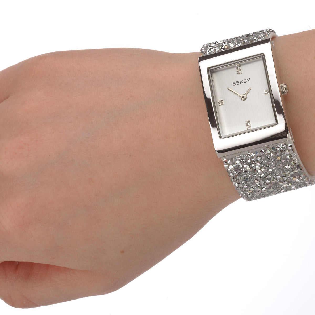 Ladies quartz watch on wrist with square dial and silver glitter stone bracelet