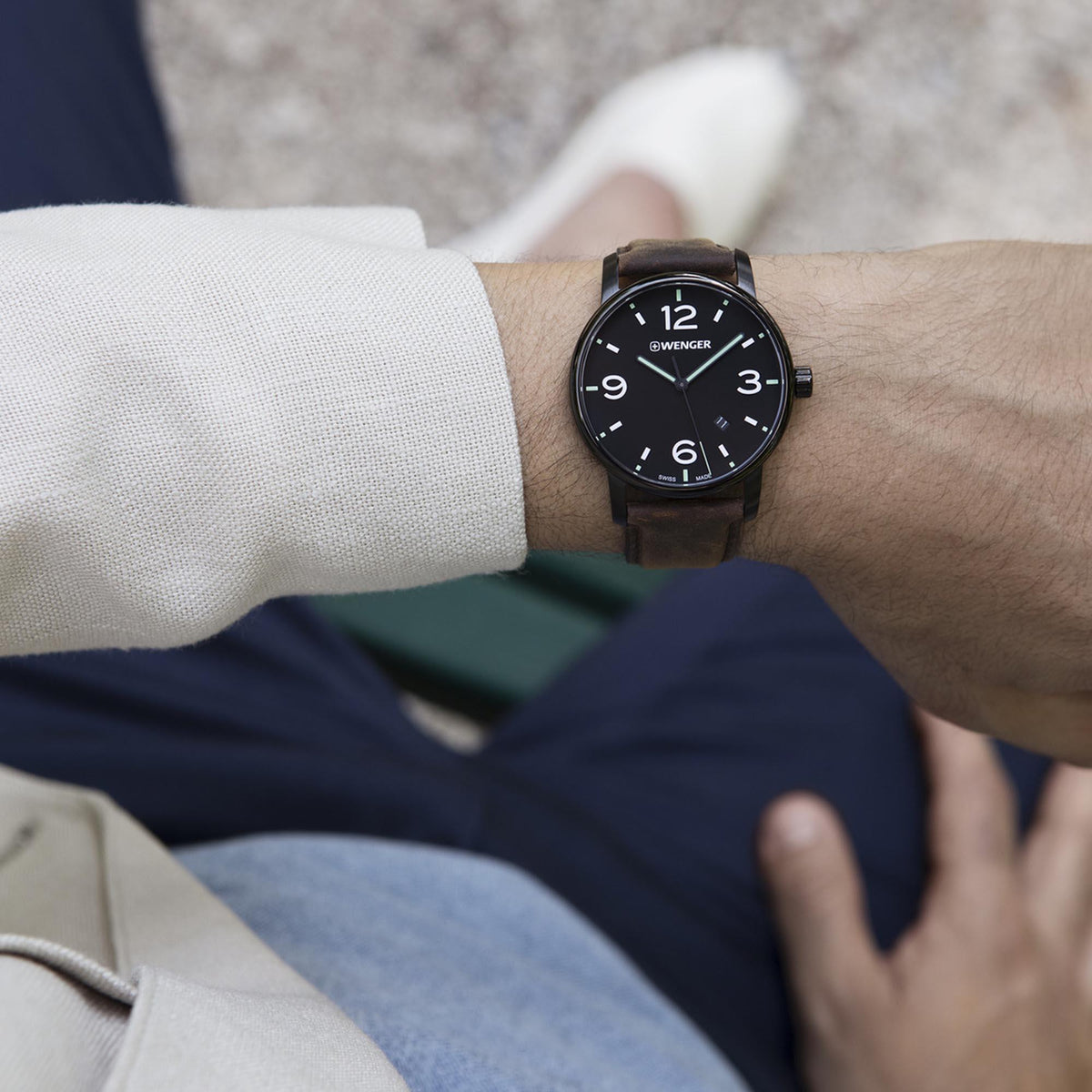 Wrist-worn men’s quartz watch with dark dial and brown leather strap