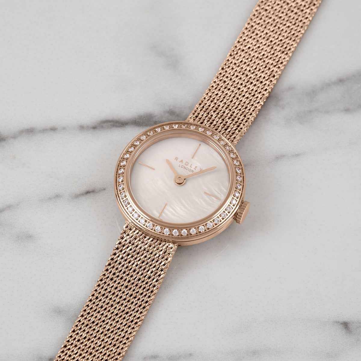 Ladies quartz wristwatch with pale pink dial, gold milanese mesh bracelet, sparkling bezel