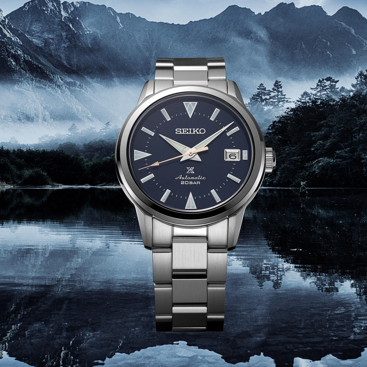 Men's stainless steel automatic watch with blue dial, metal bracelet, and date window