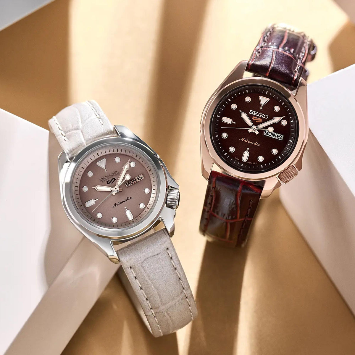 Seiko ladies watches side by side: gray dial/light strap and black dial/brown strap