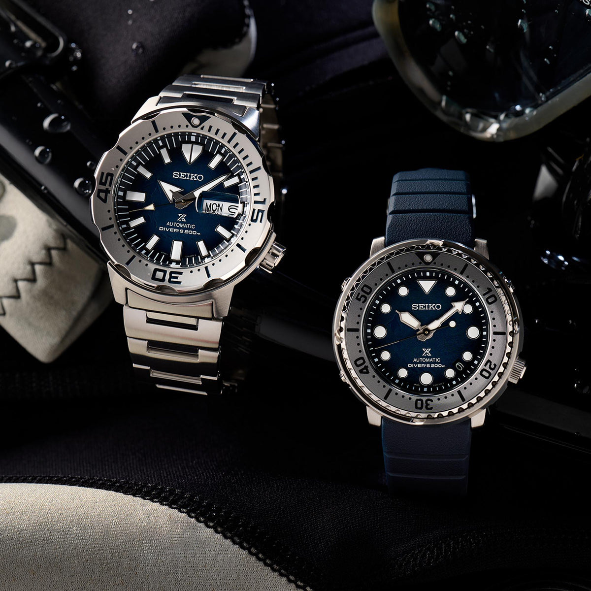 Men's diver watches with blue dials: steel bracelet on left, navy silicone strap on right