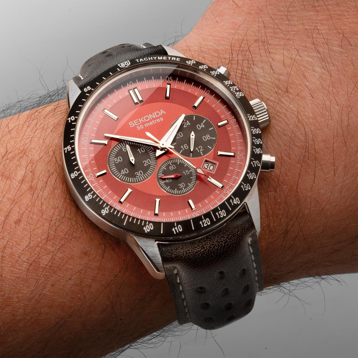 Men's chronograph watch with red dial, black tachymeter bezel, black leather strap