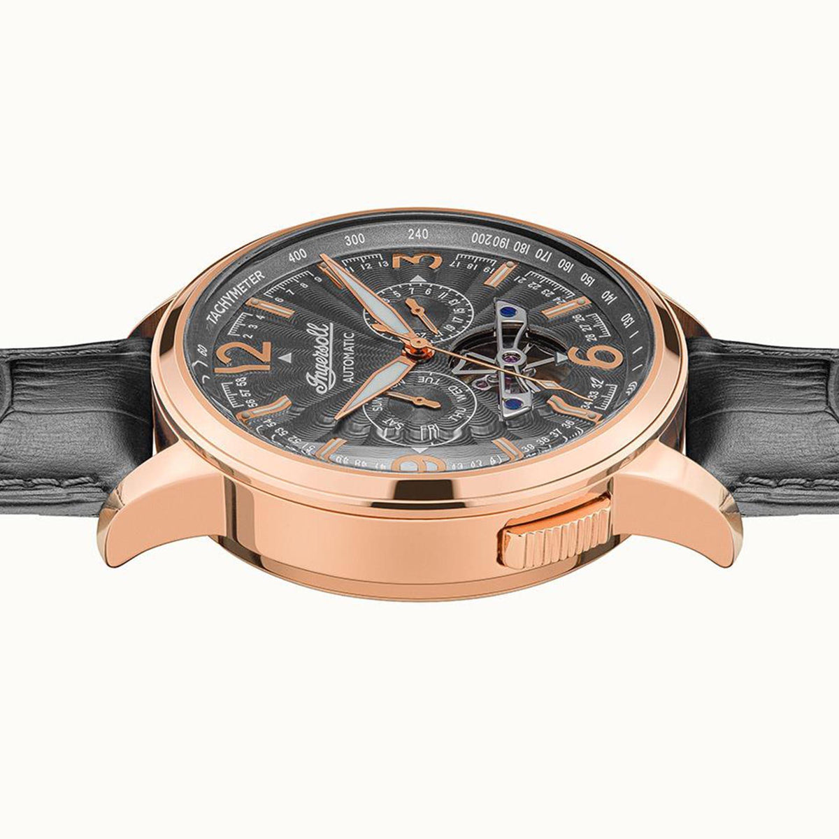 Ingersoll automatic watch angled view with rose-gold bezel, black dial, and black leather strap.