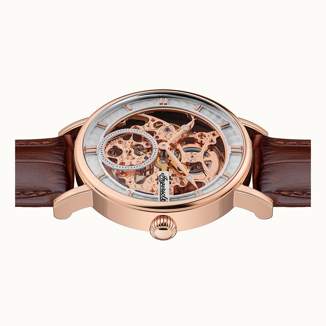Automatic watch front view featuring open-work dial, rose-gold case, and brown leather strap