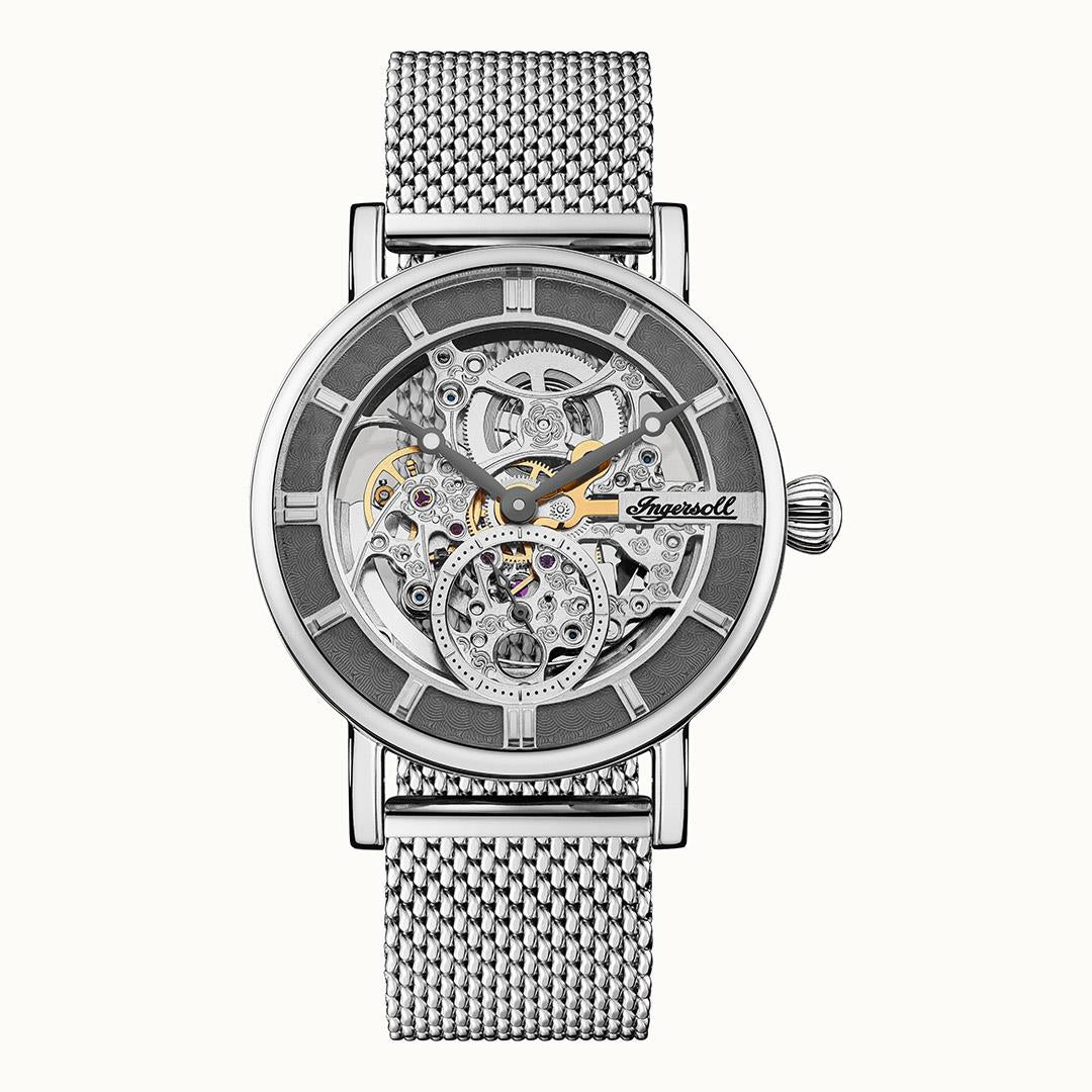 Men's automatic skeleton watch with grey dial, silver case, and Milanese mesh band.