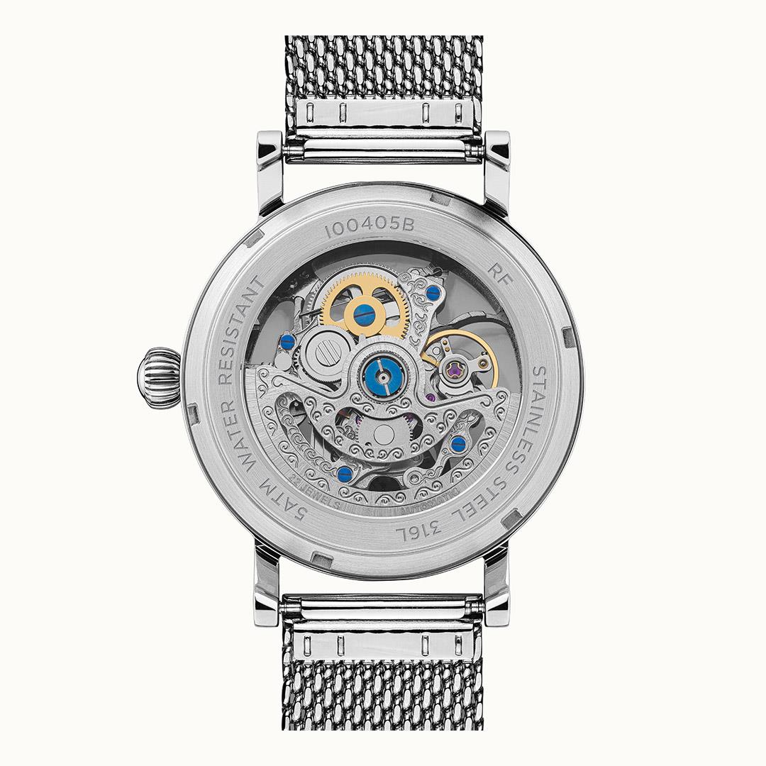 Stainless automatic watch case with exposed movement on grey face, metal milanese strap