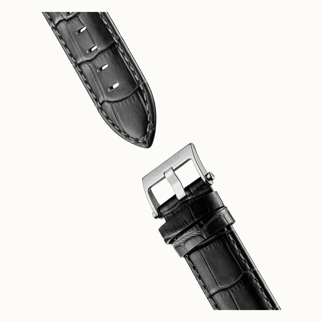 Black leather strap detail with silver buckle and metal keeper
