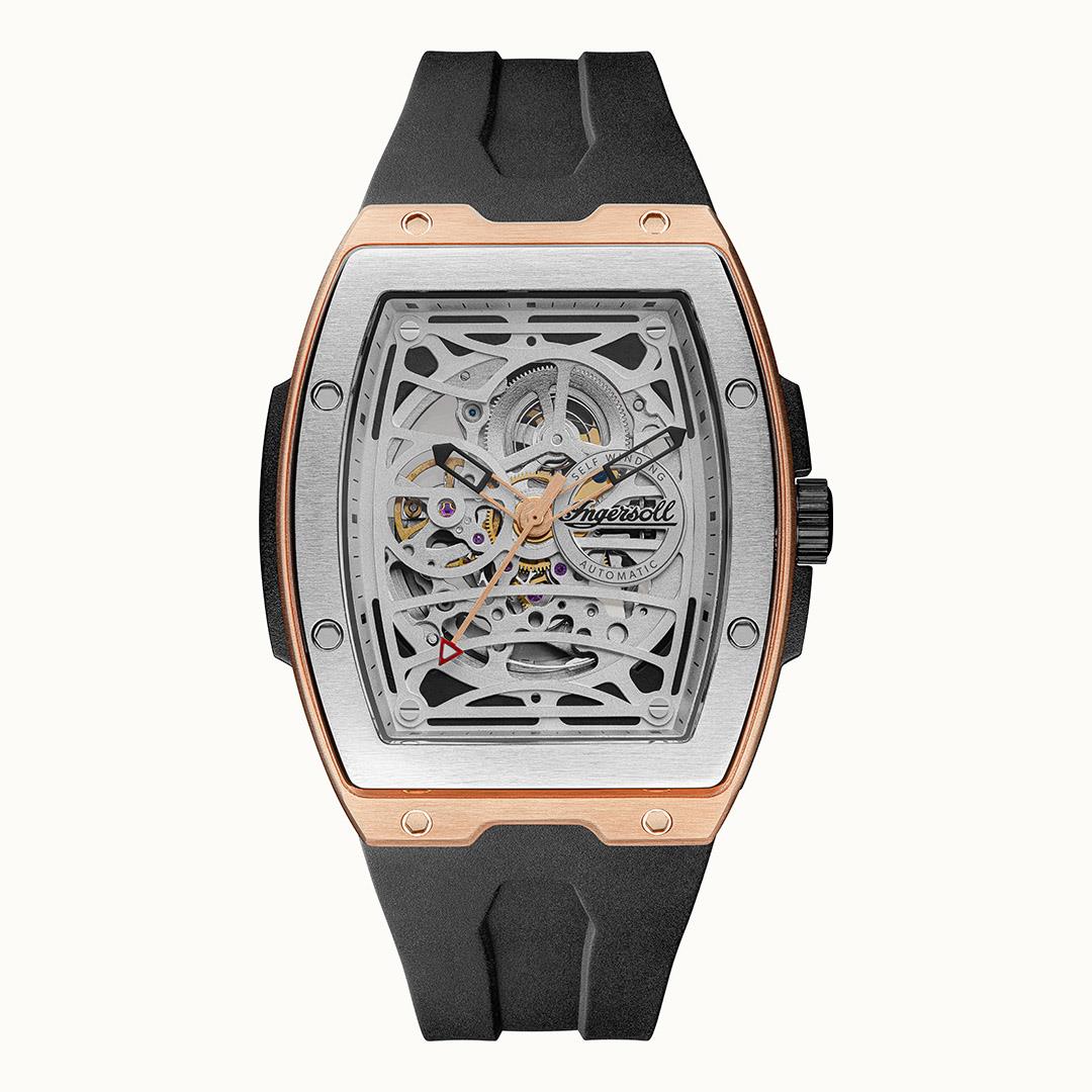 Men's skeleton automatic watch with black rubber strap and rose-gold square bezel, open gears.