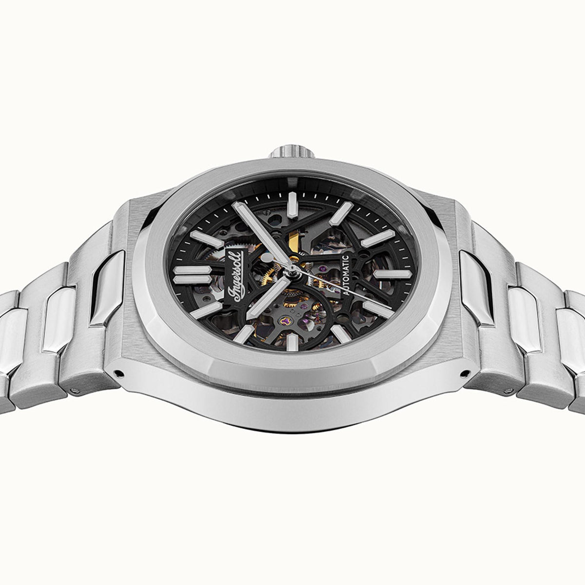Men's automatic skeleton watch with black dial and crown at top on stainless bracelet