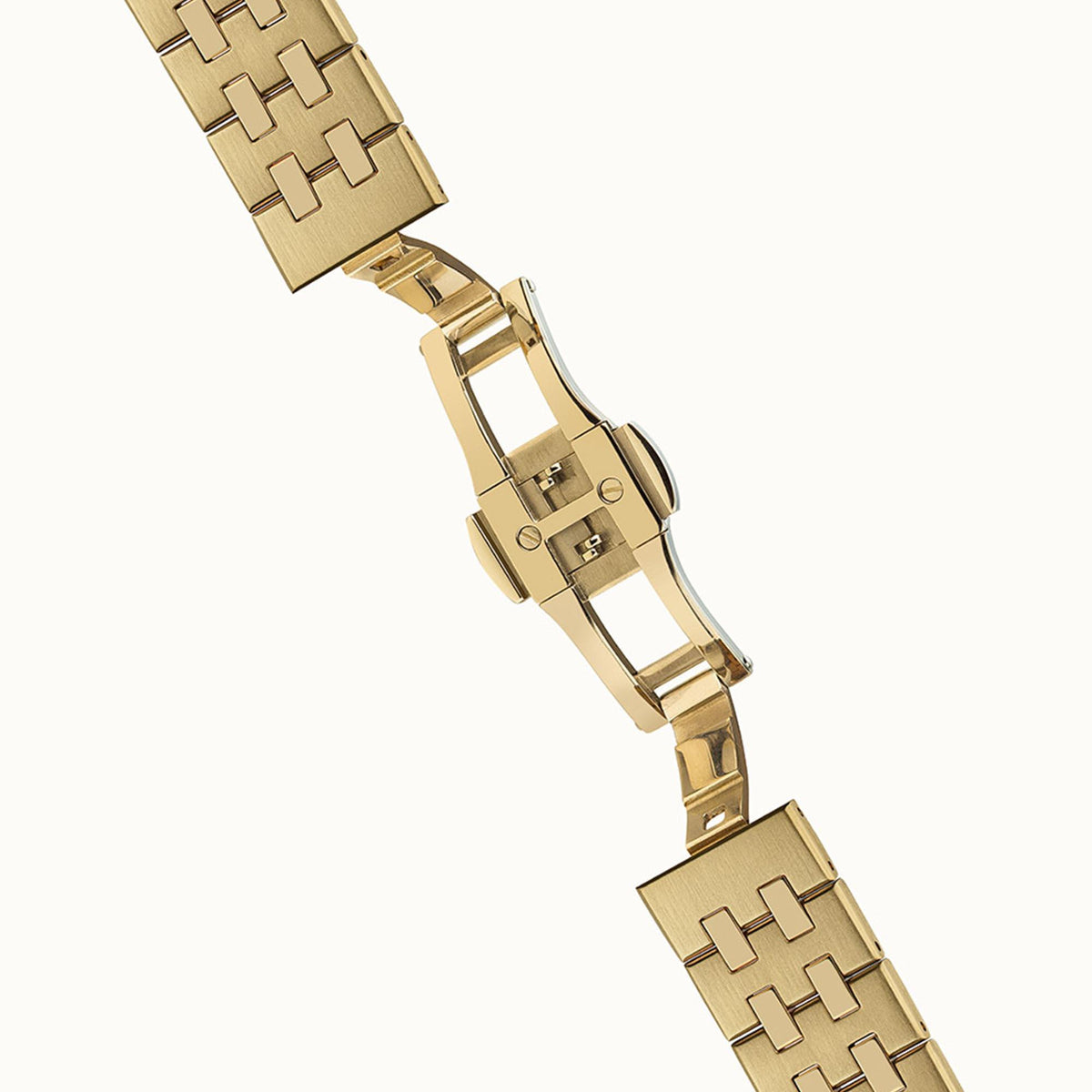 Gold-tone link bracelet with folding clasp and polished metal finish, end links visible
