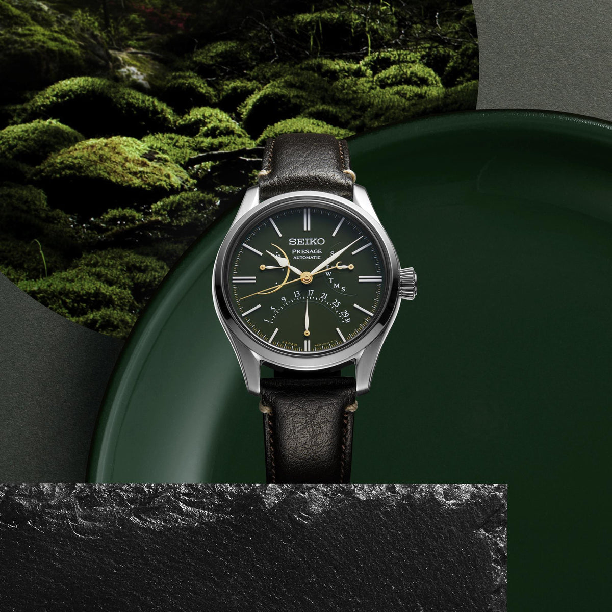 Men's automatic watch with green dial and black leather strap, silver case and bezel