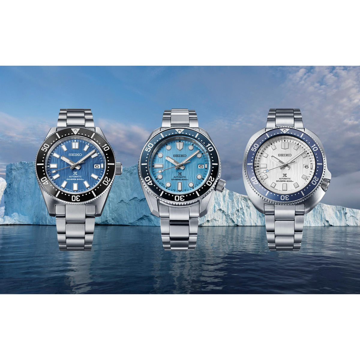 Three stainless steel diver watches shown together with blue, dark, and white dials
