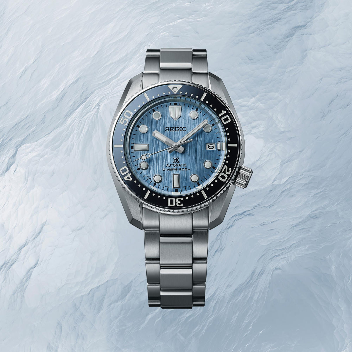 Men's diver watch with blue dial, stainless steel bracelet, and black rotating bezel