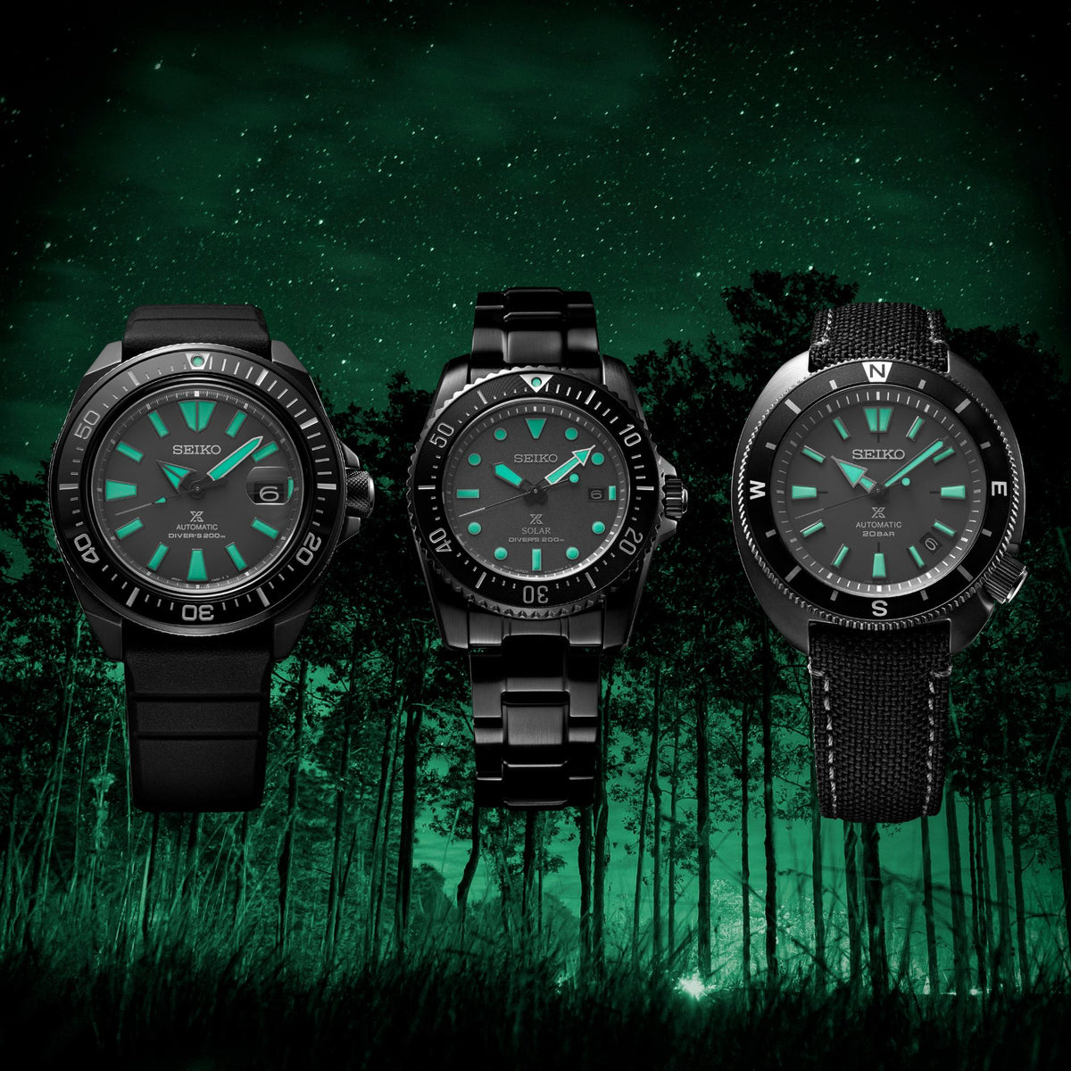 Group shot of three black Seiko diver watches with green dials and different straps