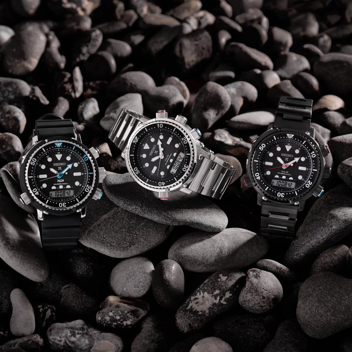 Stainless steel dive watch with black dial, three hands and date, on link bracelet.