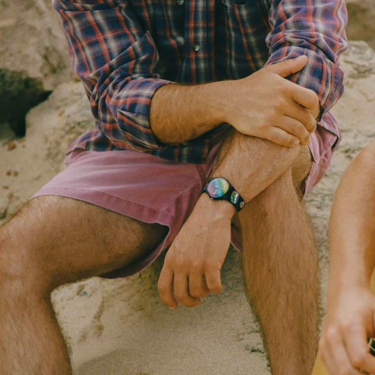 Black silicone quartz watch on arm, rainbow dial with Peace label