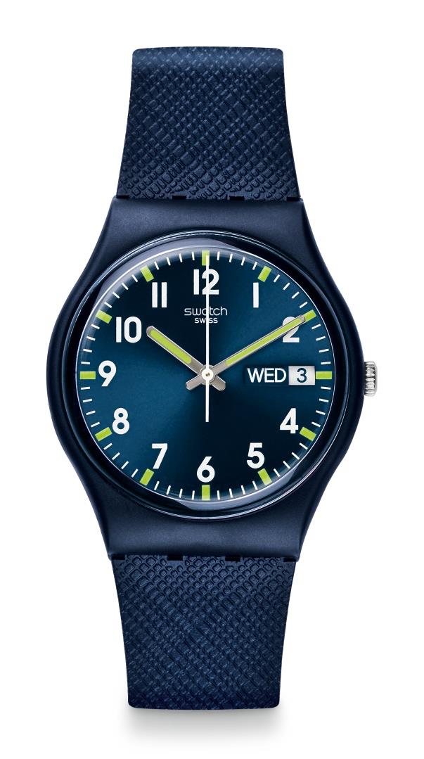 Men's Swatch watch with dark blue dial, white numerals, neon accents, blue canvas strap