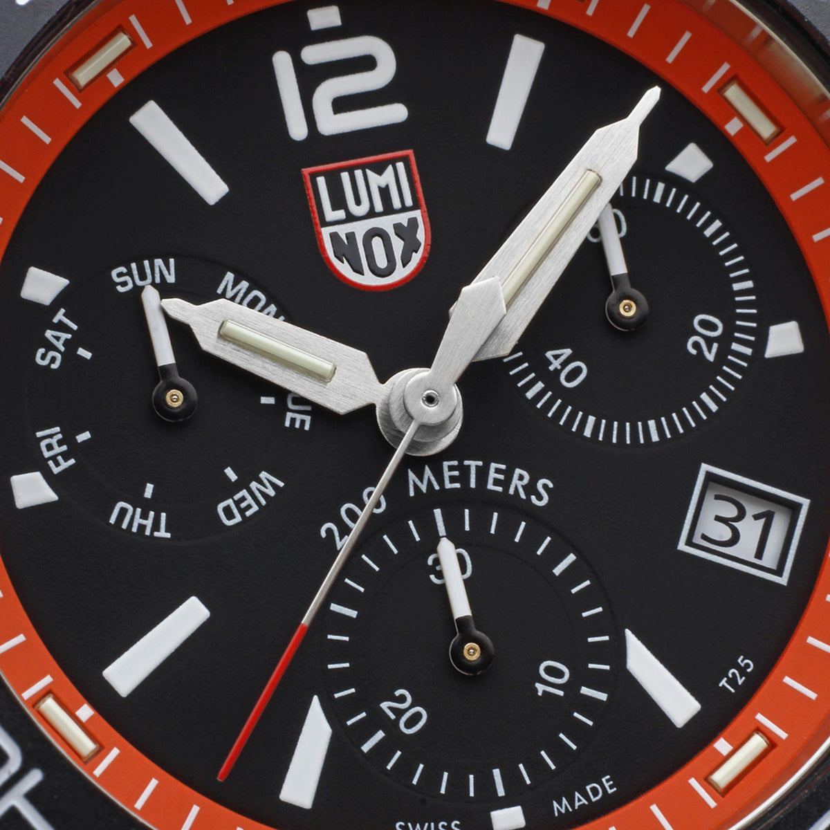 Luminox diver chronograph close-up: black dial with orange bezel and date window