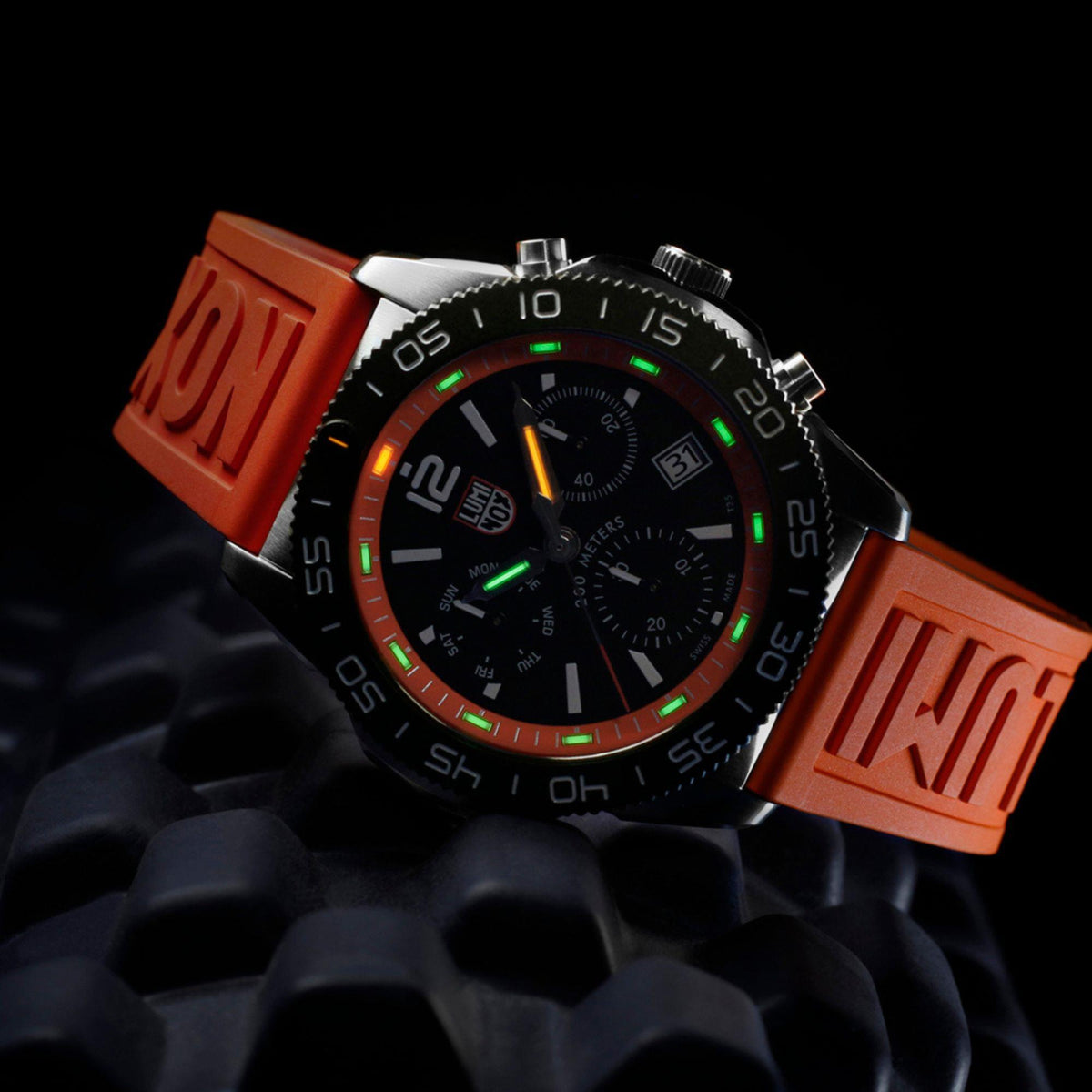 Men's diver chronograph watch with black dial and orange rubber strap, bezel markings