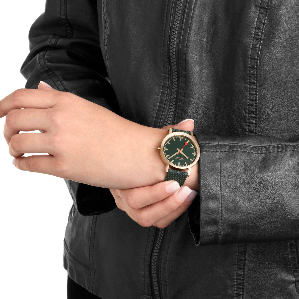 Mens wristwatch with dark green dial, gold-tone case, and green fabric strap on hand