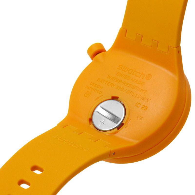 Orange watch back with circular battery cover and printed instructions