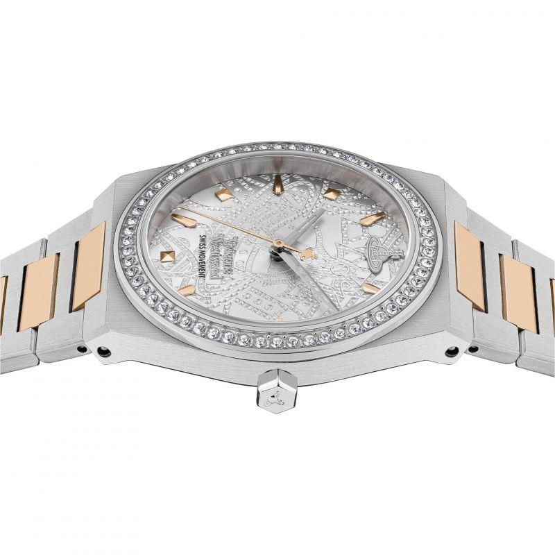 Silver watch close angle showing crystal bezel and rose-gold link accents, patterned dial
