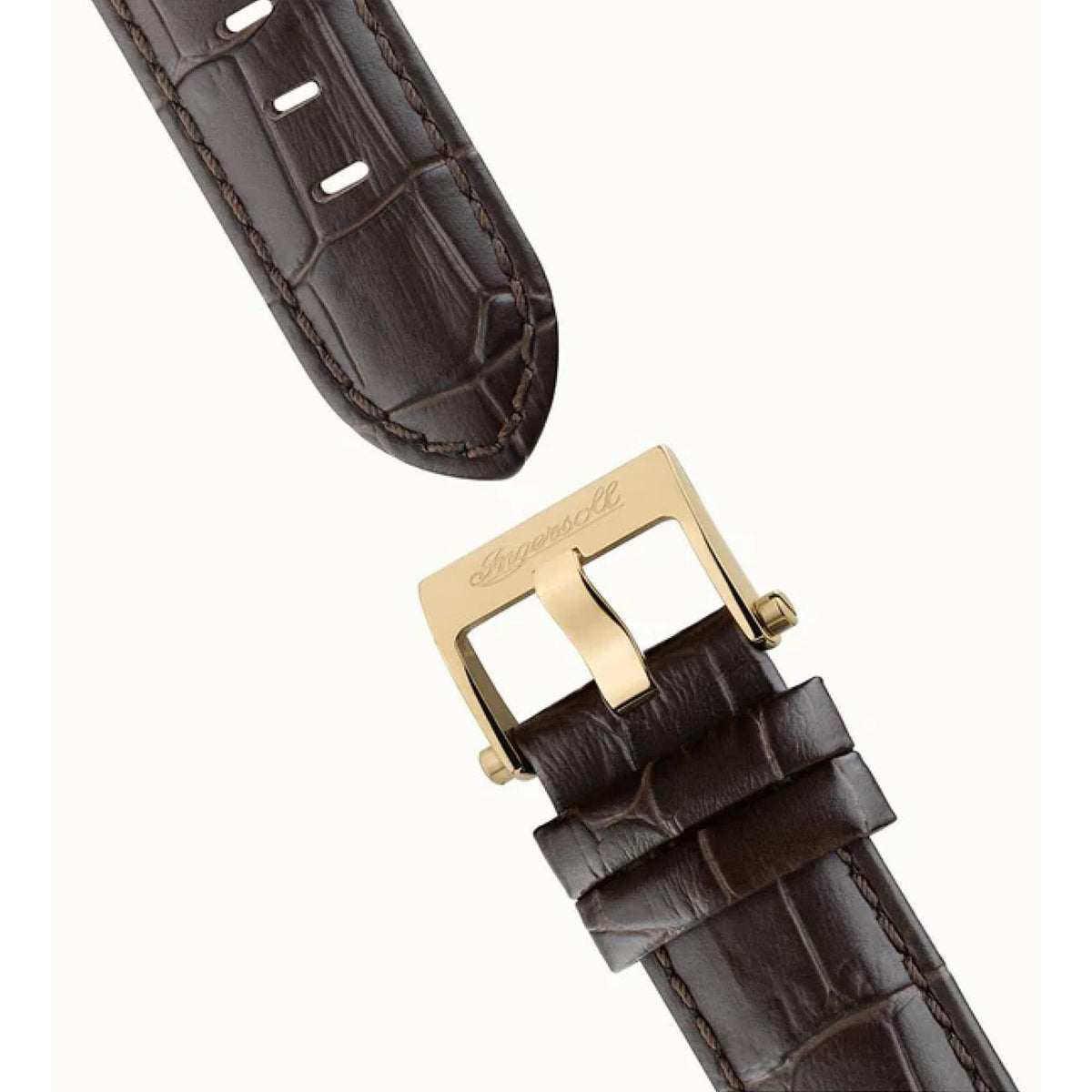 Brown leather watch strap detail with gold-tone buckle clasp on men’s automatic watch