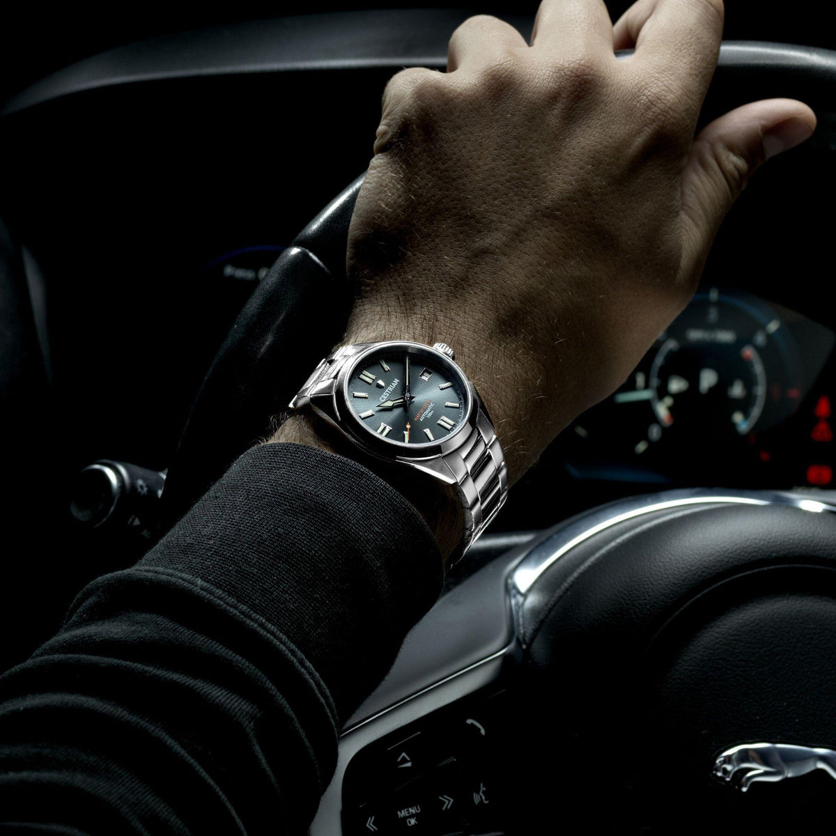 Men's wrist watch with black dial, steel bracelet, and luminous hands