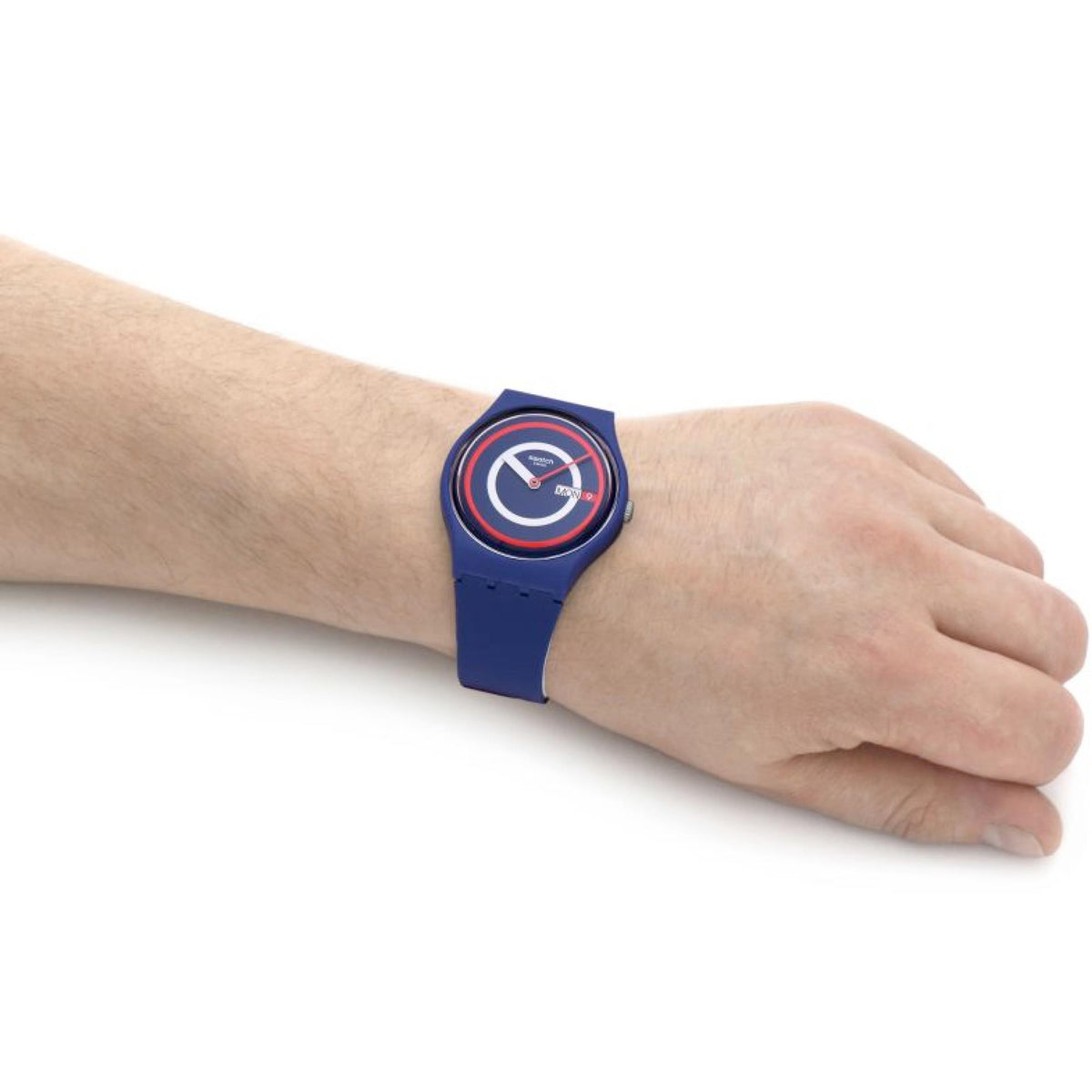 Blue quartz wristwatch with round logo dial and silicone strap, worn on wrist