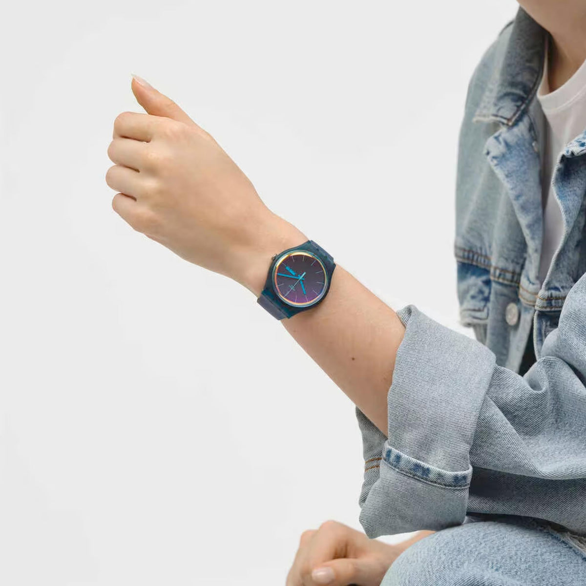 Ladies quartz watch on wrist with dark teal silicone strap and gradient blue dial