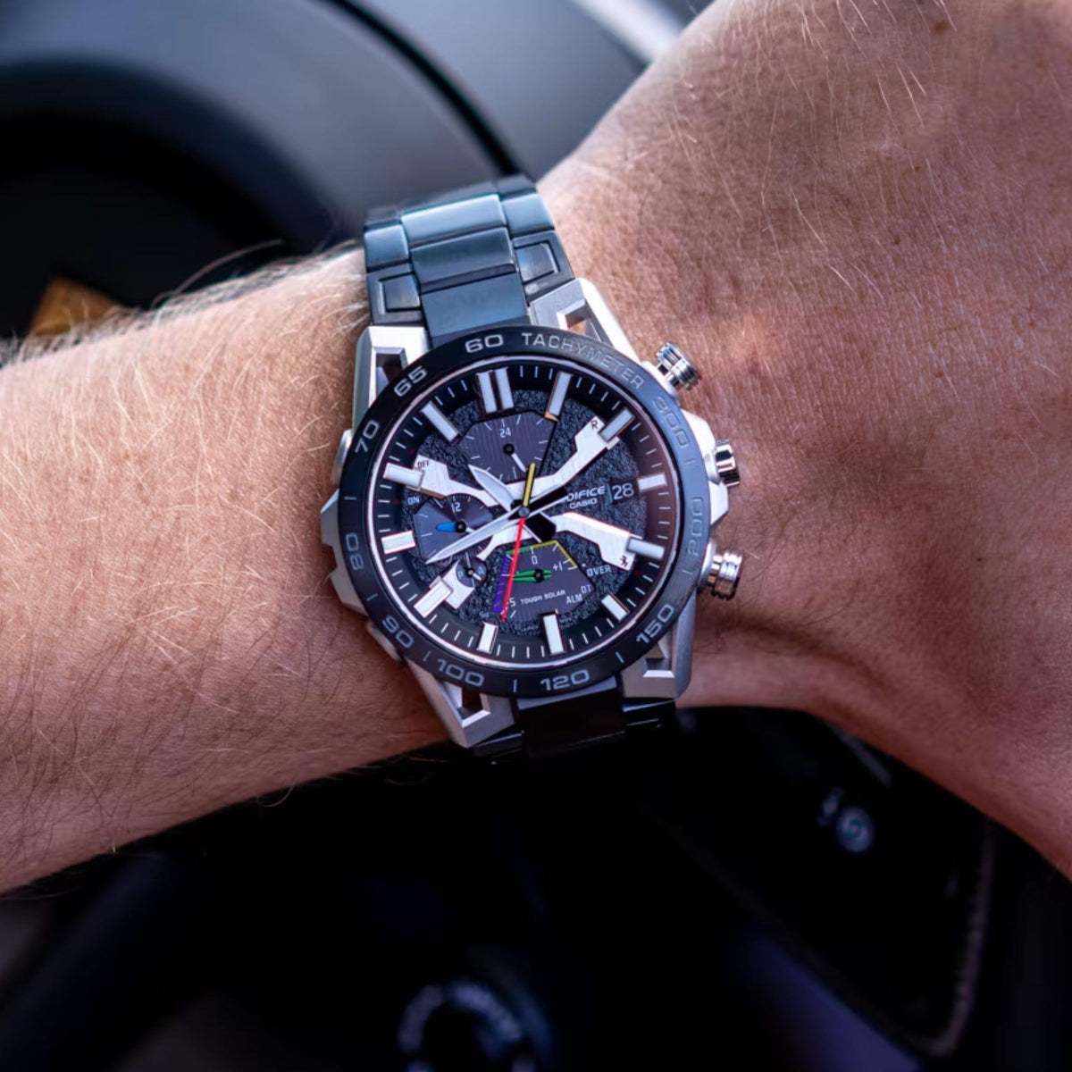 Men's solar Bluetooth chronograph watch on wrist, dark grey dial with multi-dial layout