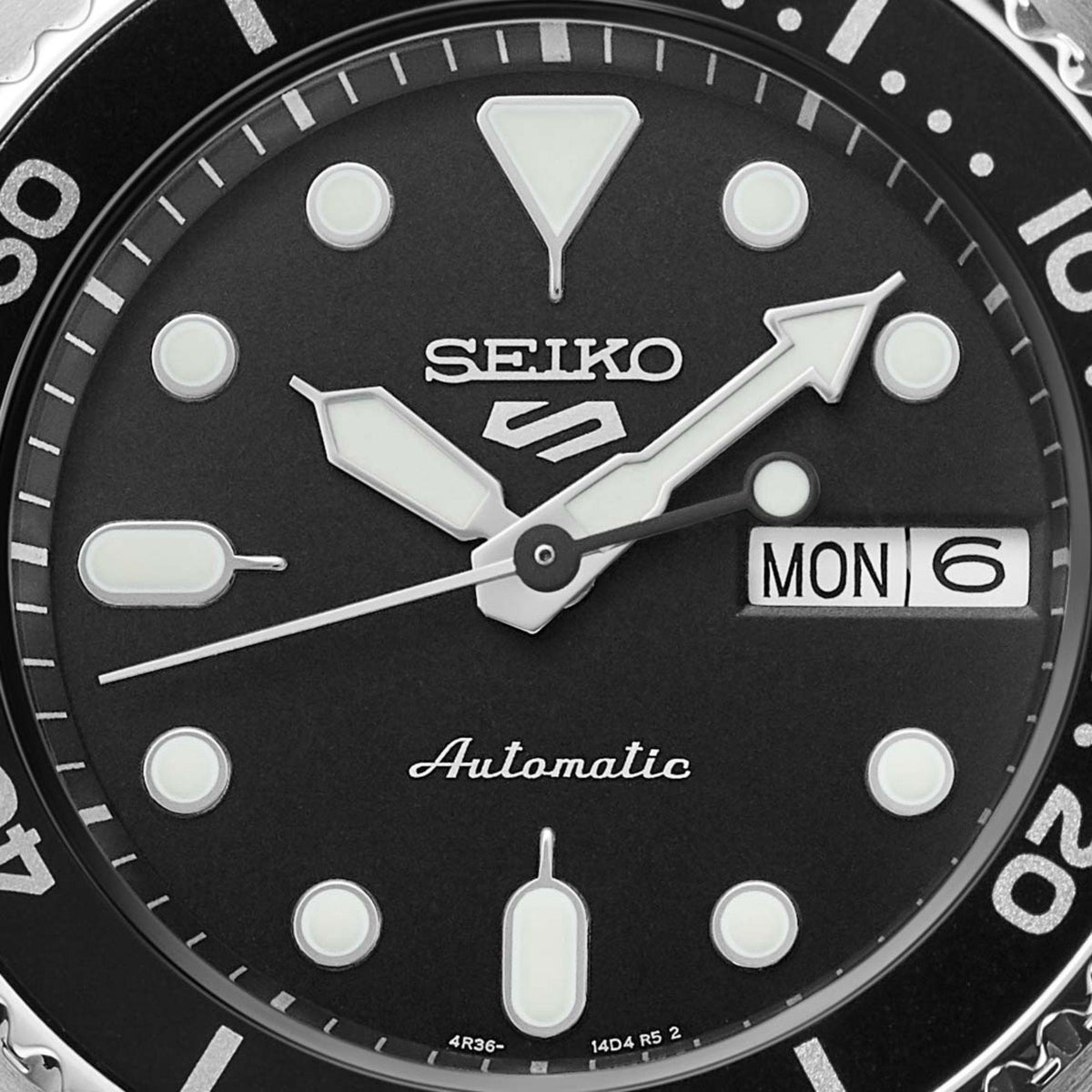 Seiko watch face with black background and white markings