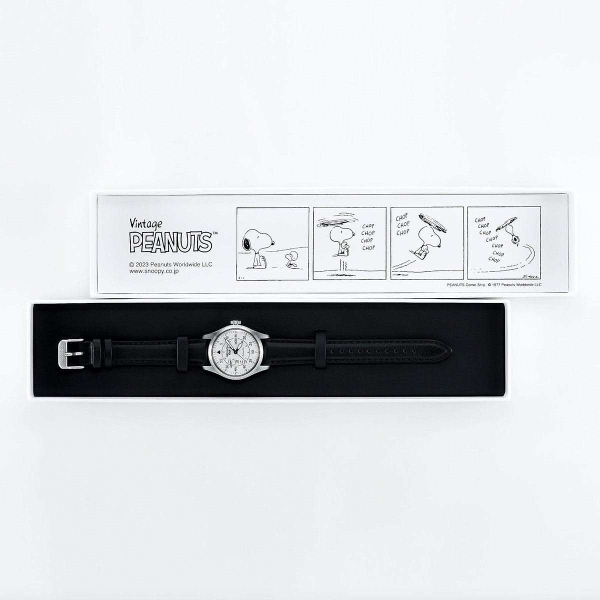 Automatic white dial wristwatch on box with black leather strap and Peanuts display card