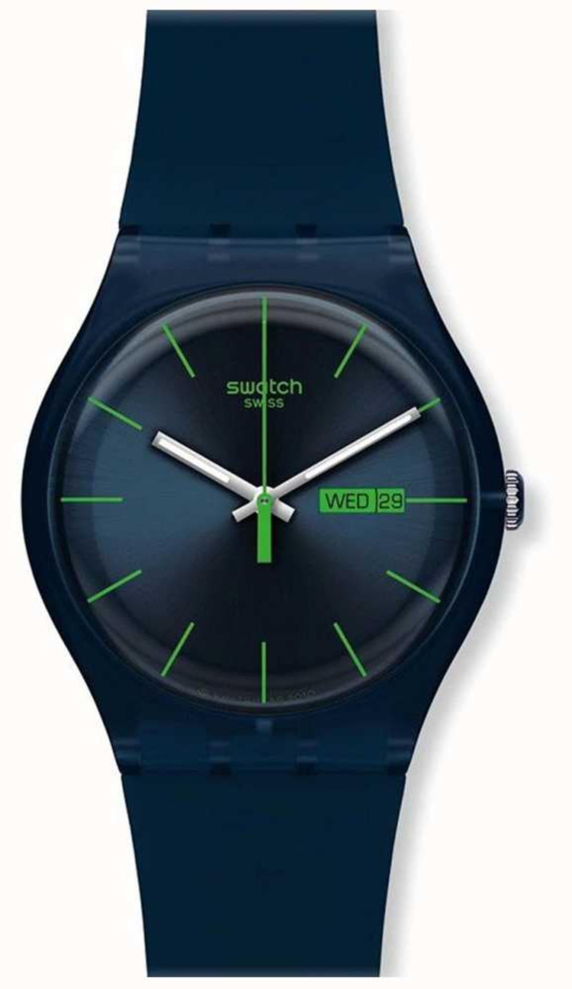 Swatch New Gent men's watch close-up, dark blue dial with green hands and markers, silicone band