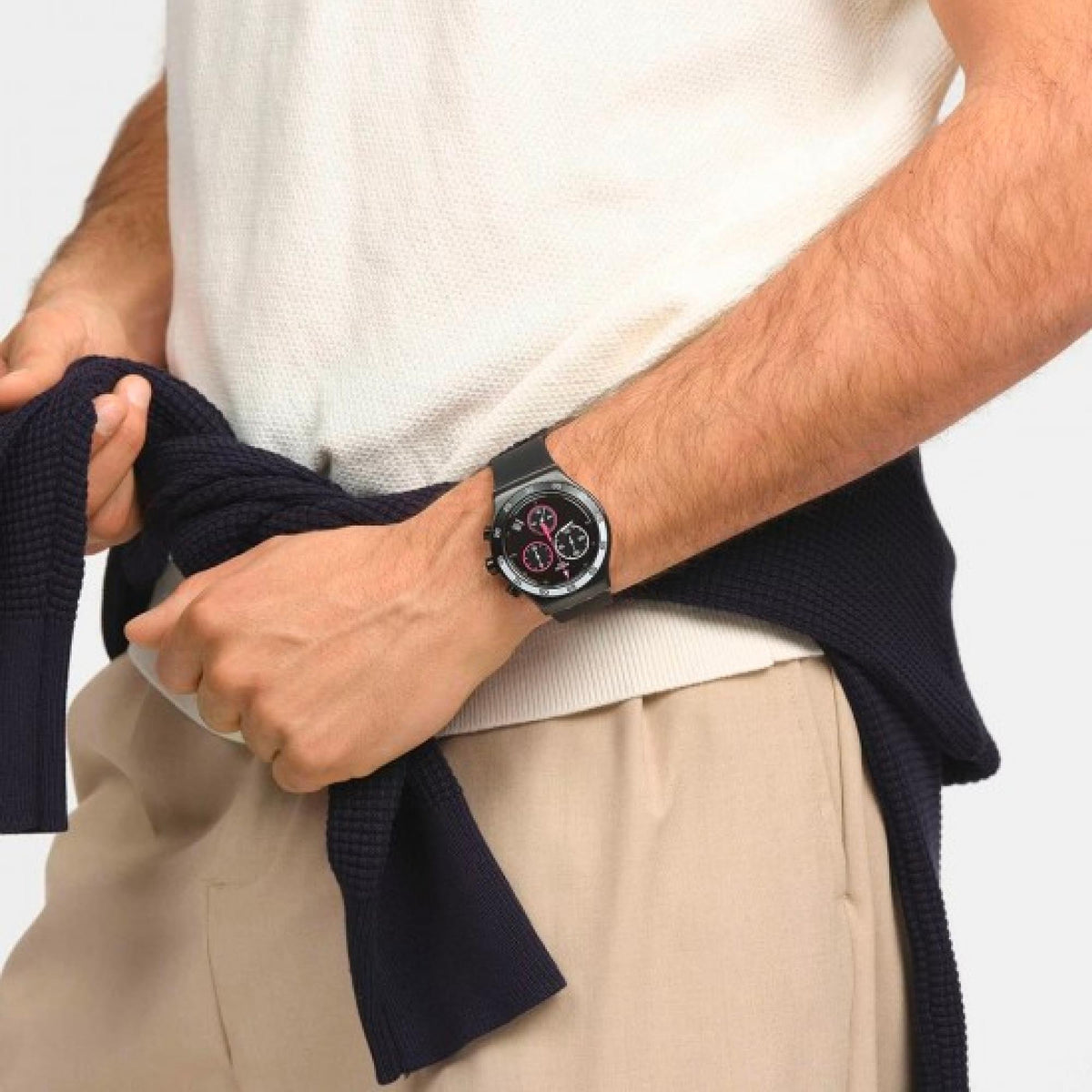 Men's black chronograph watch with magenta details on a man's wrist