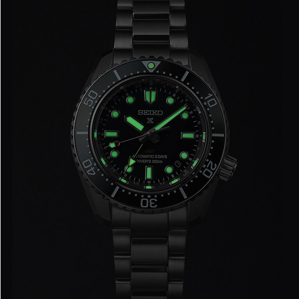 Seiko Prospex GMT diver watch with black case, green dial accents, and dark bracelet