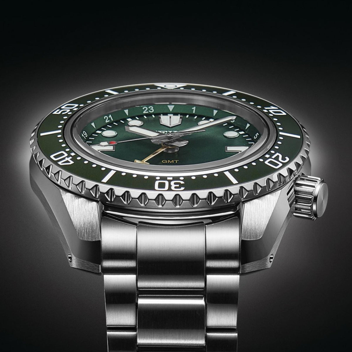 Seiko Prospex GMT diver watch with green dial, crown-side view, and steel bracelet