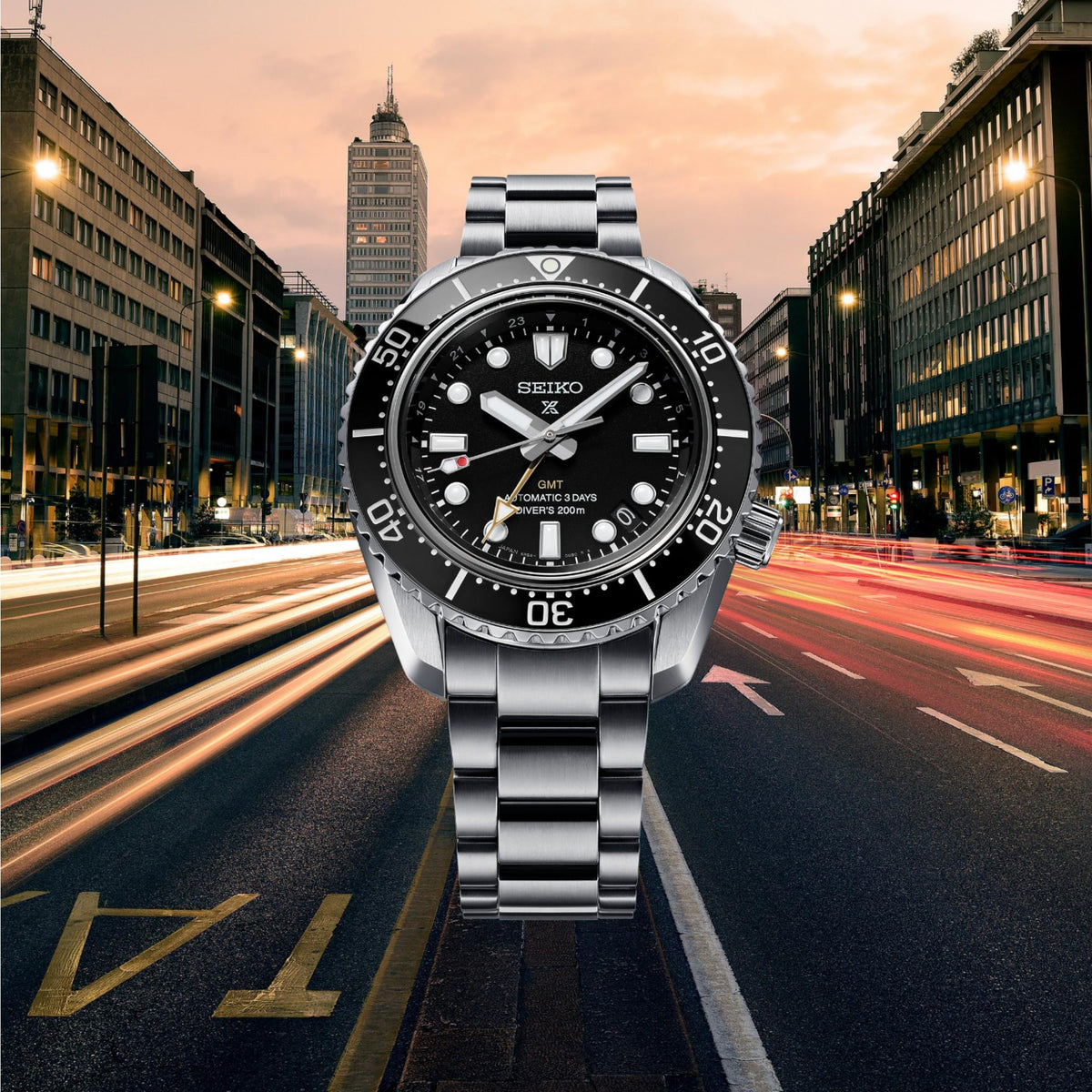 Seiko diver watch with black dial, GMT subdial, and metal bracelet