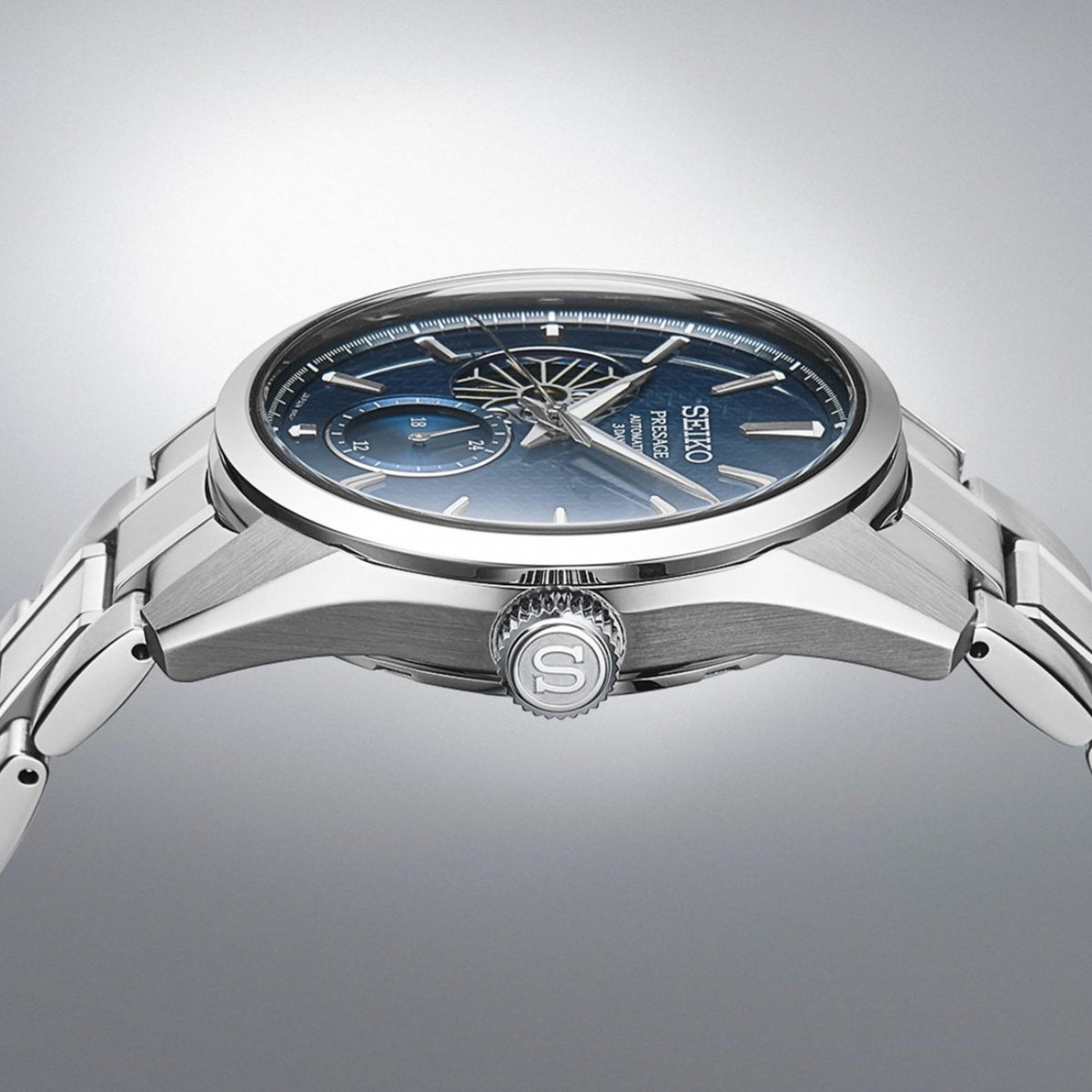 Seiko Presage open-heart watch with blue dial, metal case profile, and crown detail