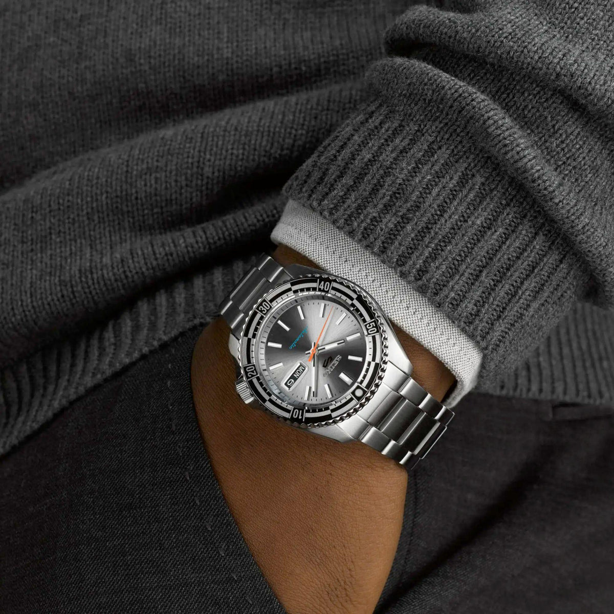 Seiko 5 Sports automatic men’s wristwatch with silver dial and black bezel with day-date