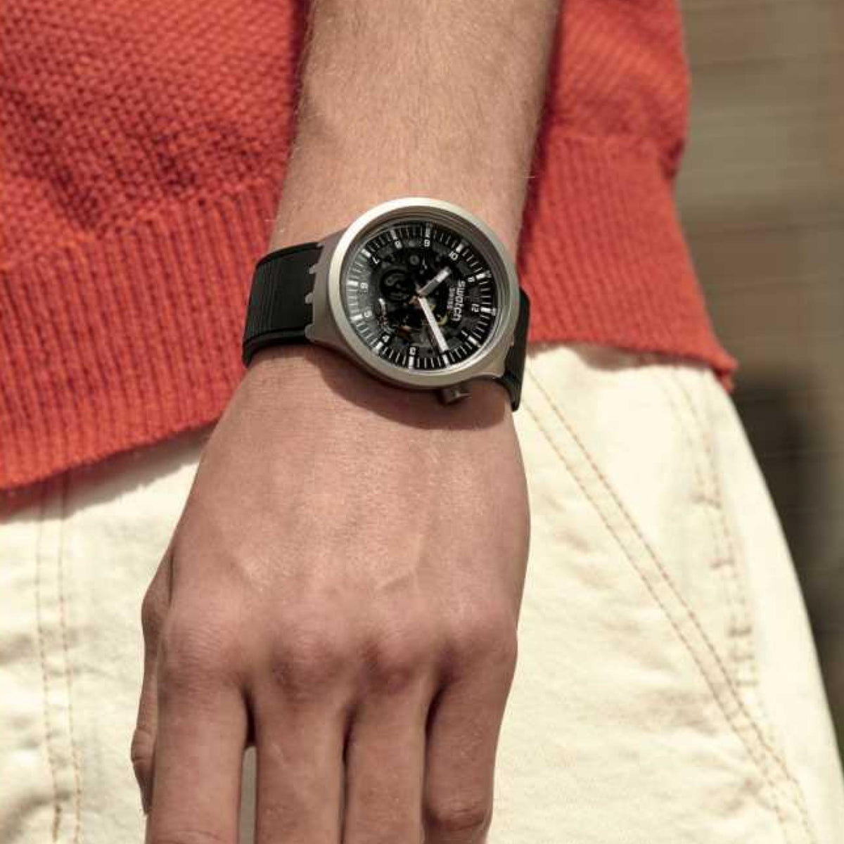 Men's Swatch Swiss watch on wrist, black dial and black rubber strap with silver case