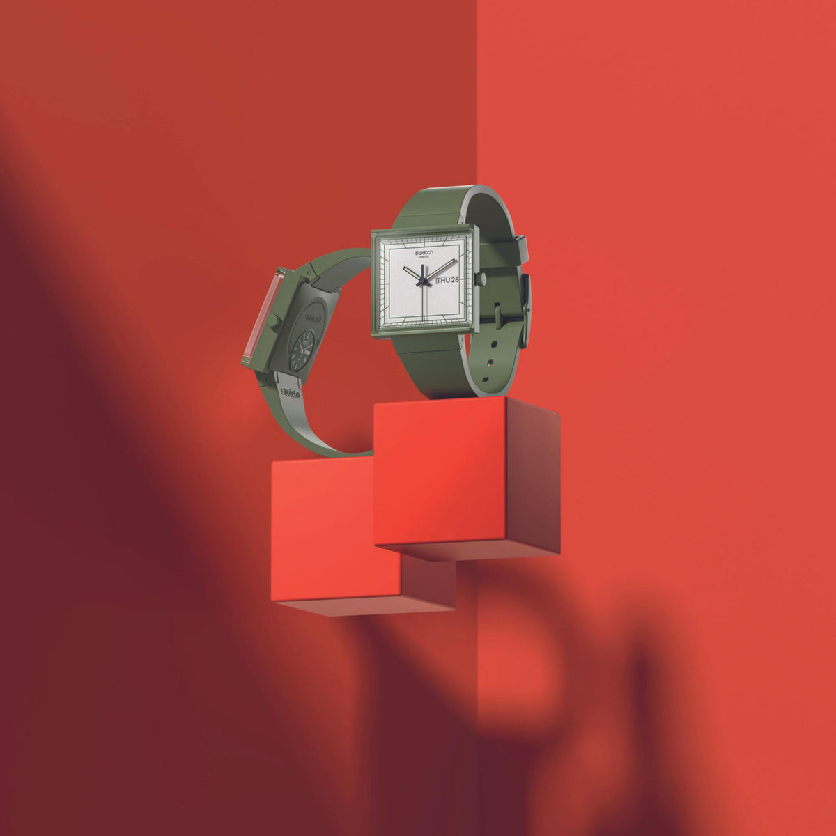 Square bioceramic watch side three-quarter view with green strap and white dial