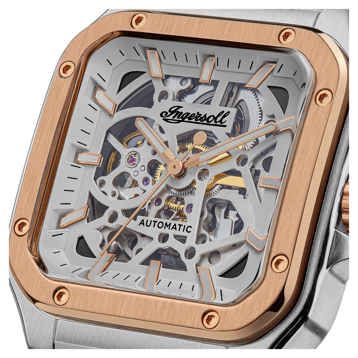 Close-up of rose-gold framed skeleton dial with automatic text and grey gearwork